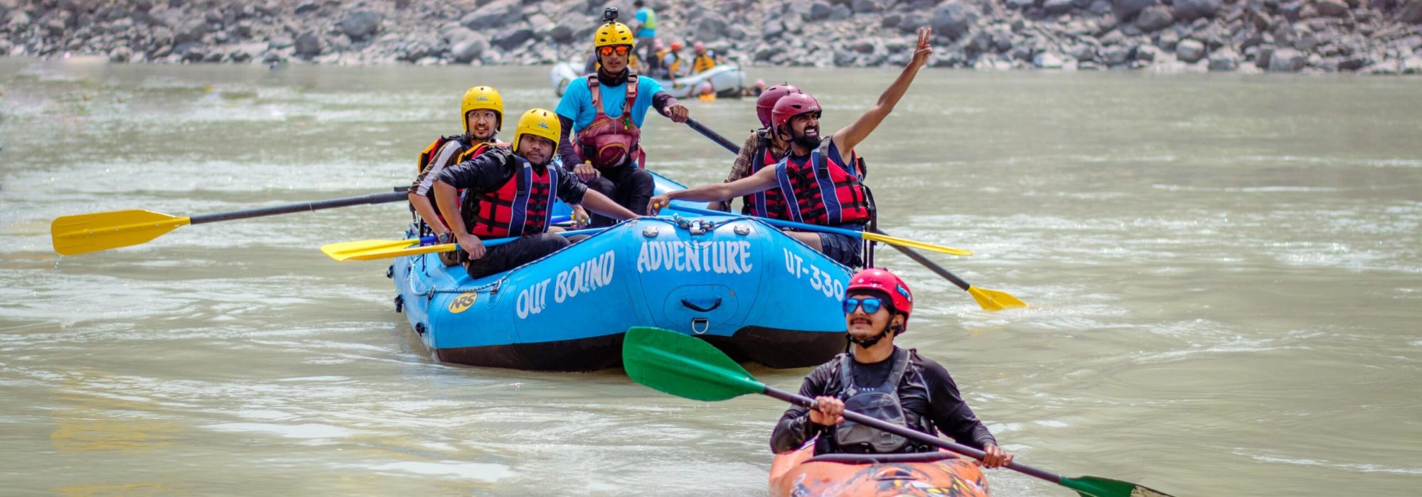 Group enjoying rafting and kayaking on the Ganges in Rishikesh, India.